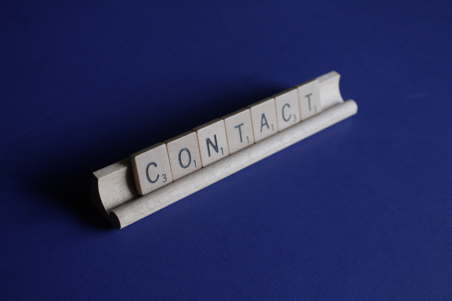 Scrabble rack showing the word Contact