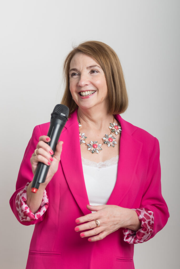 Women in pink Jacket Holding Microphone